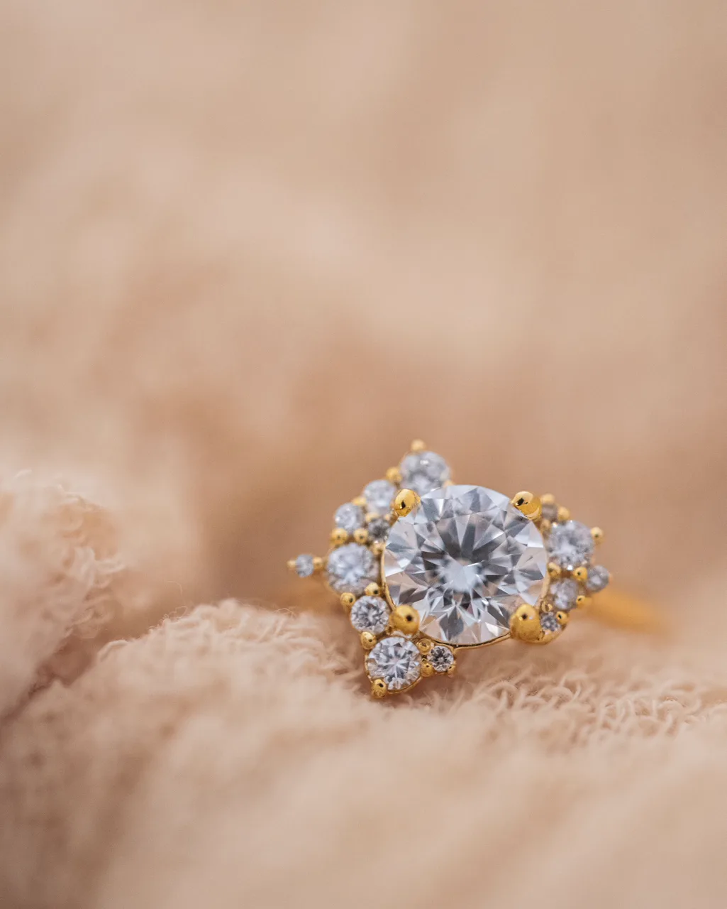 Custom gold engagement ring photographed to show the finished stone setting.